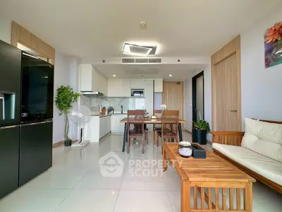 Modern open-plan living room and kitchen with sleek design and natural light