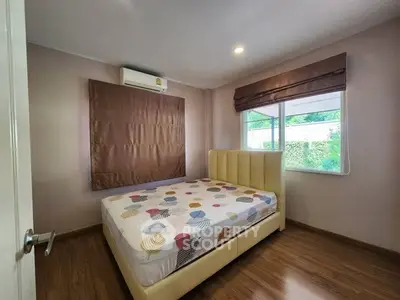 Cozy bedroom with modern decor and large window for natural light