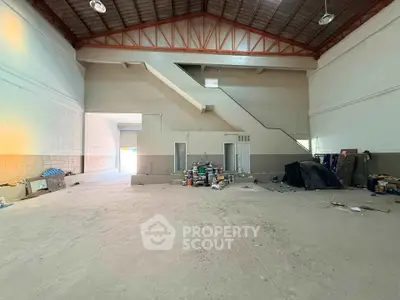 Spacious industrial warehouse with high ceilings and ample storage space, ideal for business operations.