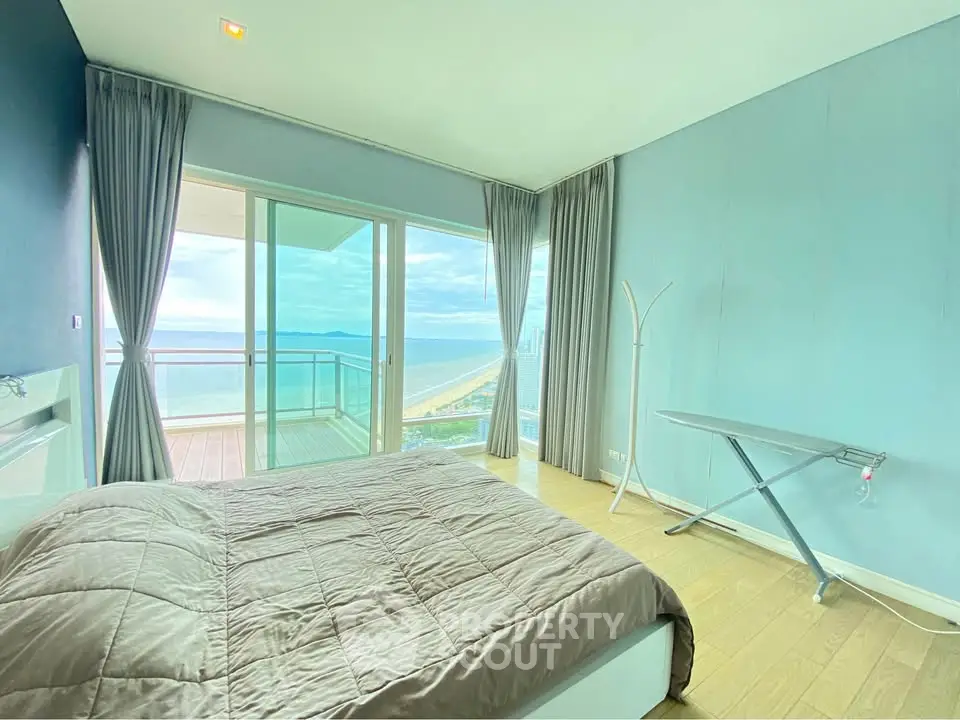 Stunning bedroom with ocean view and balcony access in modern apartment