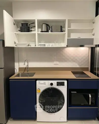 Modern kitchen with sleek appliances and ample storage space