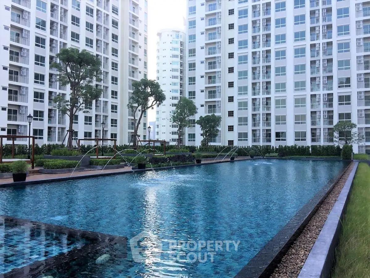 Luxurious condominium with a stunning outdoor pool and modern architecture.