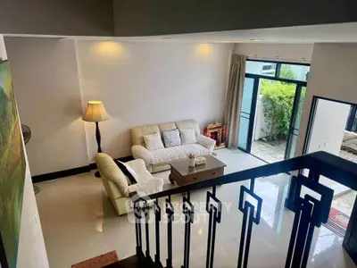 Spacious living room with elegant decor and garden view, perfect for relaxation and entertaining.