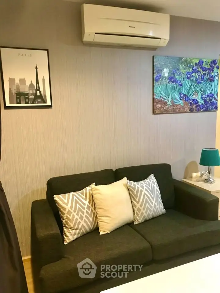 Cozy living room with modern decor and air conditioning, perfect for relaxation.