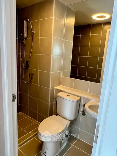 Modern bathroom with sleek tiles and shower in a contemporary apartment.