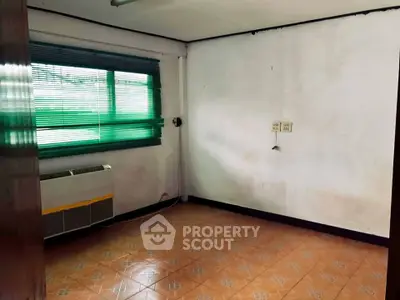 Spacious room with tiled floor and large window, perfect for customization.