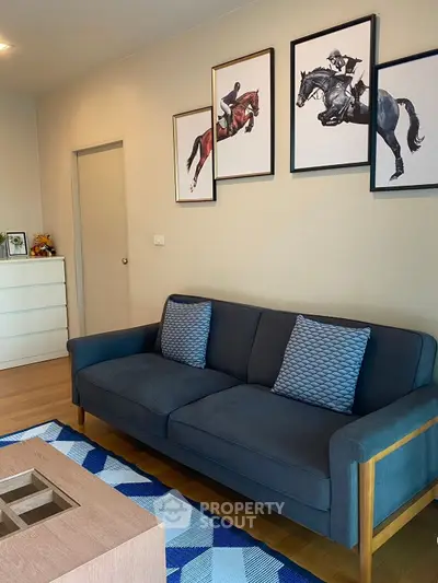Stylish living room with modern decor and equestrian-themed artwork