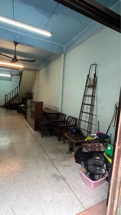 Spacious storage area with minimal furnishings and ladder, ideal for organization.