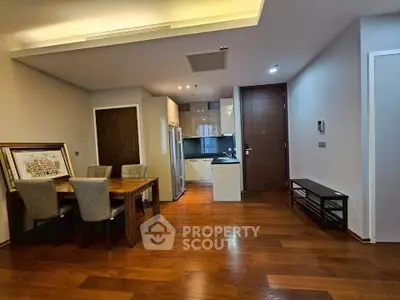 Spacious modern living room with wooden flooring and open kitchen layout