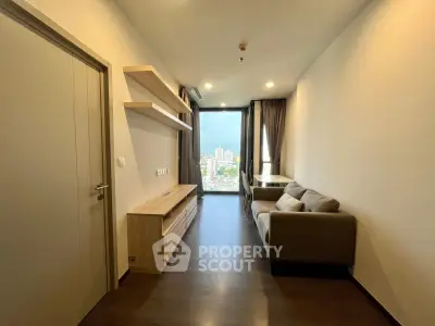 Modern living room with city view, featuring sleek furniture and minimalist design.