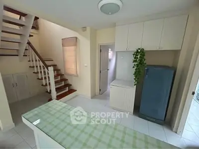 Charming interior with staircase and modern kitchen appliances in cozy home