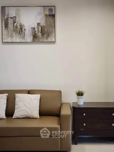 Stylish living room with modern sofa and elegant wall art, perfect for urban living.