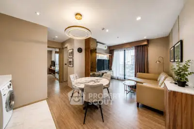 Modern living room with elegant decor and open layout, featuring a cozy seating area and stylish dining space.