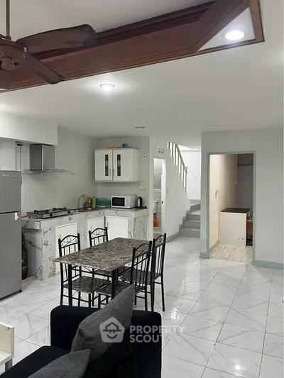 Spacious open-plan kitchen and dining area with modern appliances and stylish decor.