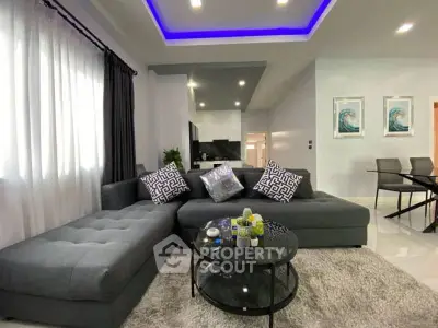 Modern living room with stylish gray sectional sofa and chic decor