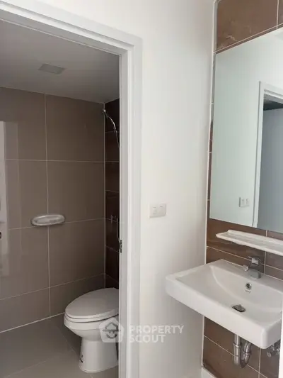 Modern bathroom with sleek fixtures and neutral tiles