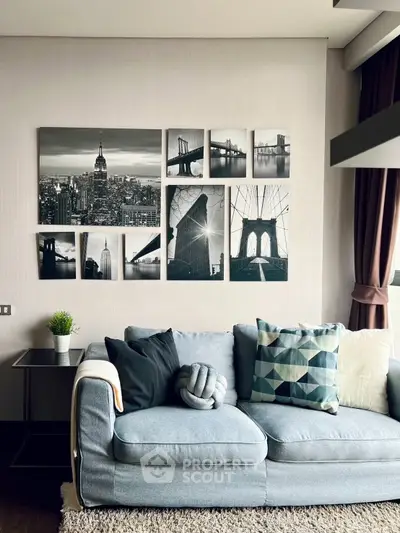 Stylish living room with modern decor and cityscape wall art, featuring a cozy sofa and geometric cushions.