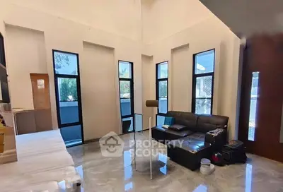 Spacious modern living room with high ceilings and large windows for natural light.