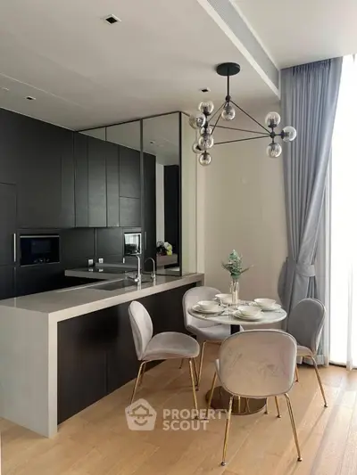 Modern kitchen with sleek black cabinetry and elegant dining area