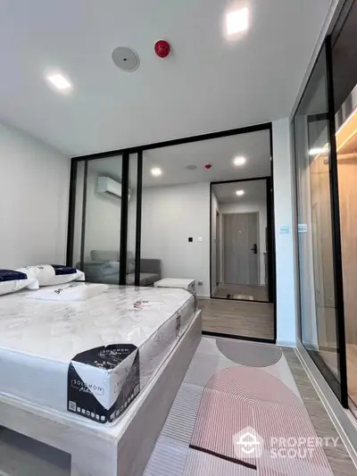 Modern bedroom with glass partition and stylish decor