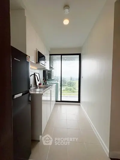 Modern kitchen with sleek appliances and scenic balcony view