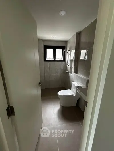 Modern bathroom with sleek design and natural light from window