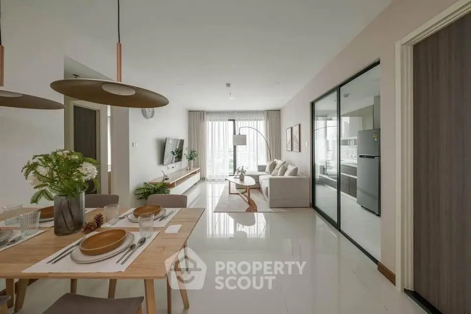 Modern open-plan living room with dining area and large windows