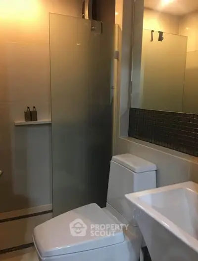 Modern bathroom with sleek fixtures and glass shower enclosure