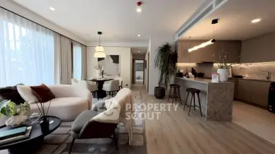 Modern open-plan living room with stylish kitchen and dining area