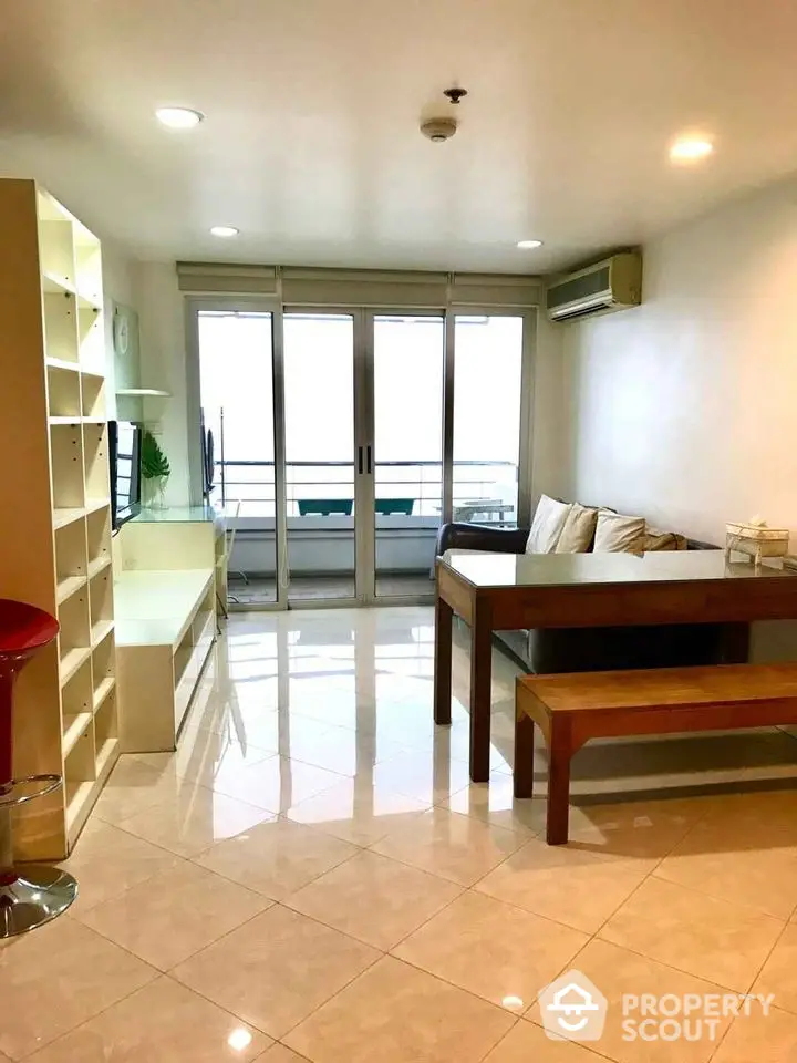 Spacious living room with modern furniture and balcony access