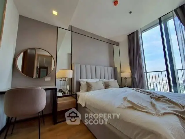 Luxurious bedroom with modern decor and city view balcony