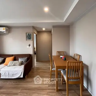 Modern living room with wooden flooring and cozy dining area