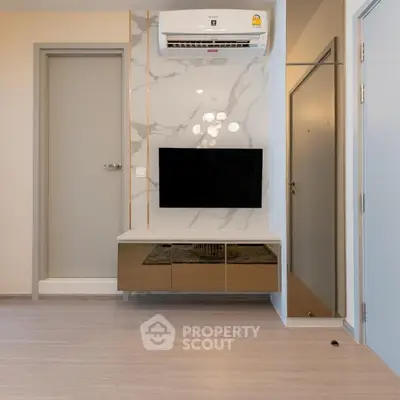 Modern living room with wall-mounted TV and air conditioning unit, featuring sleek design and elegant decor.