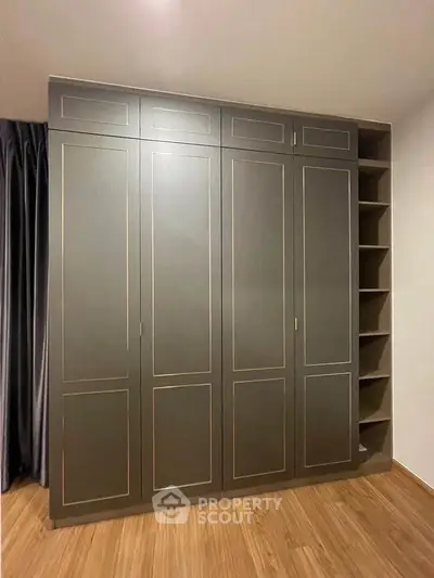 Elegant built-in wardrobe with sleek design and ample storage space in modern interior.
