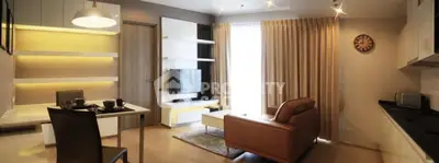 Modern living room with stylish furniture and open kitchen layout