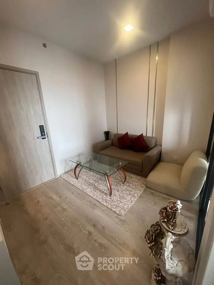 Cozy living room with modern sofa and glass coffee table in a stylish apartment.