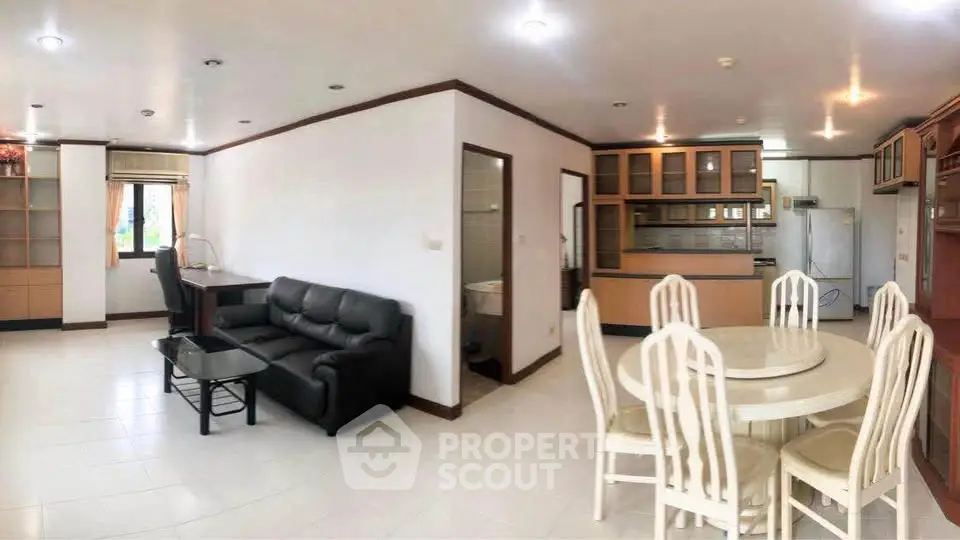 Spacious open-plan living and dining area with modern furnishings and ample natural light.