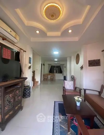 Elegant living room with ornate ceiling and stylish furniture