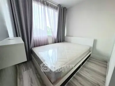 Bright bedroom with large window and modern decor