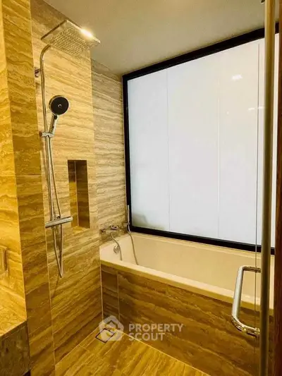 Luxurious bathroom with modern shower and bathtub in elegant marble design.