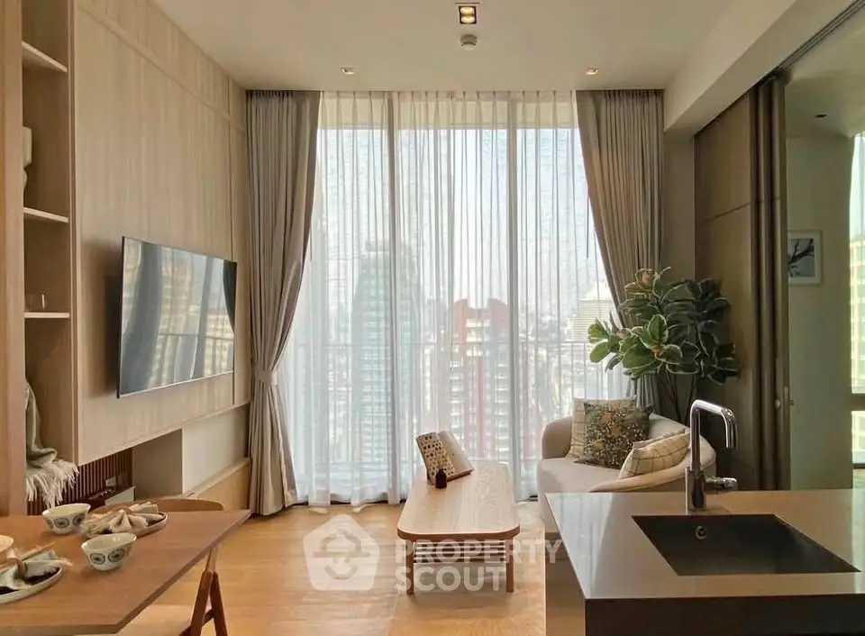 Modern living room with floor-to-ceiling windows and stylish decor in a high-rise apartment.