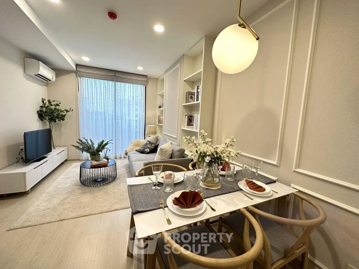 Elegant living room with modern decor and dining area, featuring stylish furniture and ambient lighting.