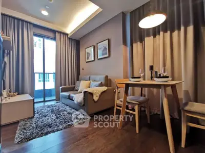 Cozy living room with modern decor and dining area, featuring warm lighting and stylish furnishings.