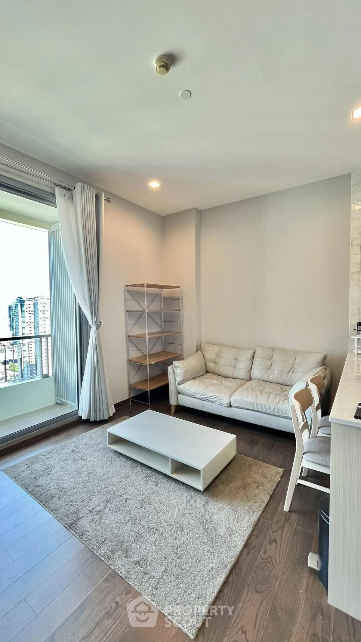 Modern living room with balcony view and stylish furniture