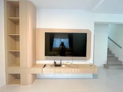 Modern living room with sleek TV unit and built-in shelves, perfect for stylish home entertainment.