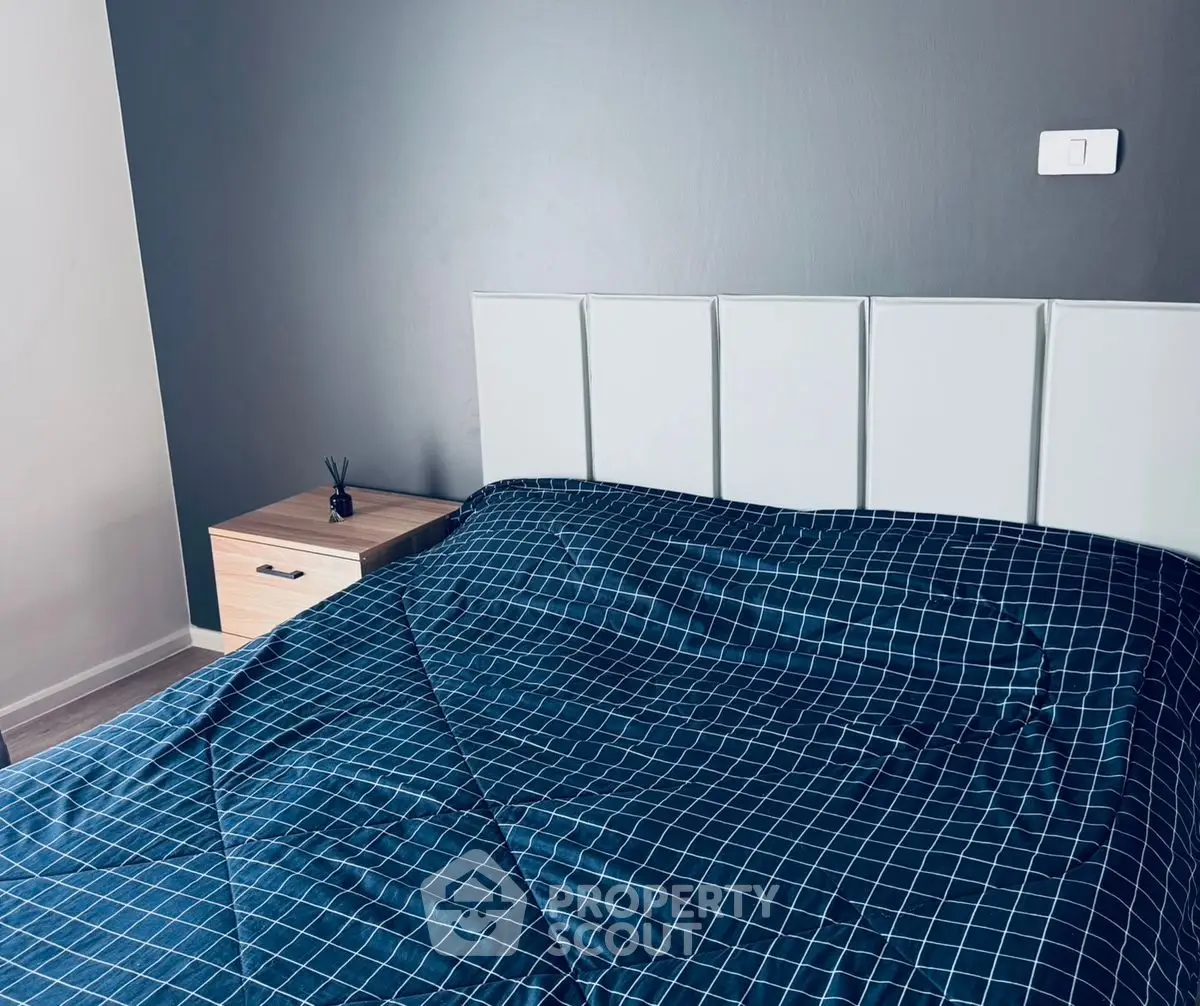 Modern bedroom with stylish headboard and checkered bedding