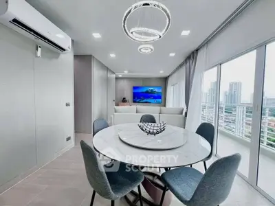 Modern living room with elegant dining area and city view balcony