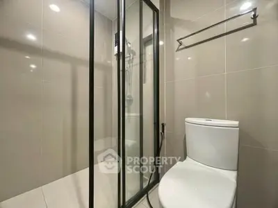 Modern bathroom with sleek shower enclosure and contemporary toilet design.