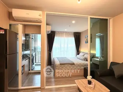 Modern apartment interior with cozy bedroom and open living area, featuring stylish decor and ample natural light.