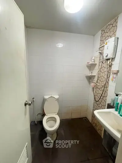 Compact bathroom with shower and toilet in minimalist design